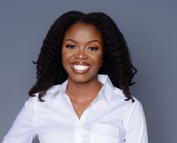 Photo of a woman with long dark hair in a white shirt