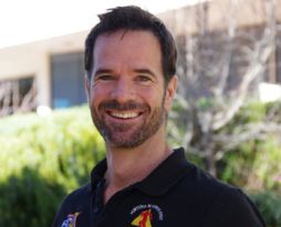 Headshot of a male professor with short dark hair