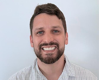 Image of a young man with short hair and a big smile