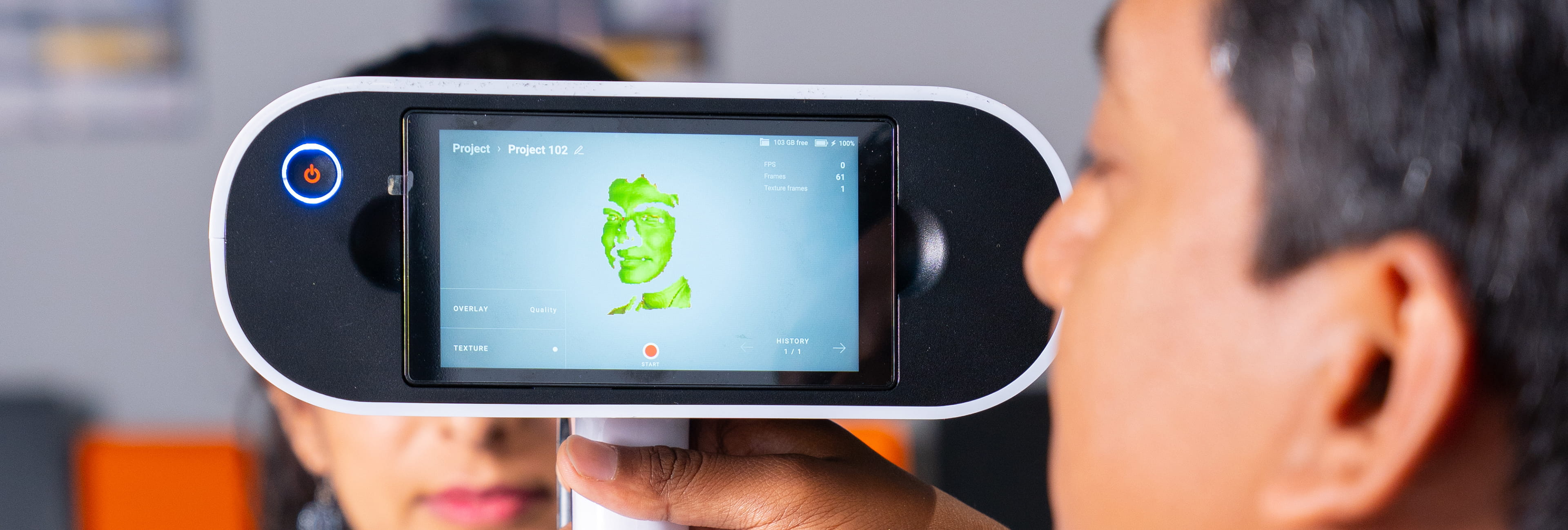 Man watching device screen.